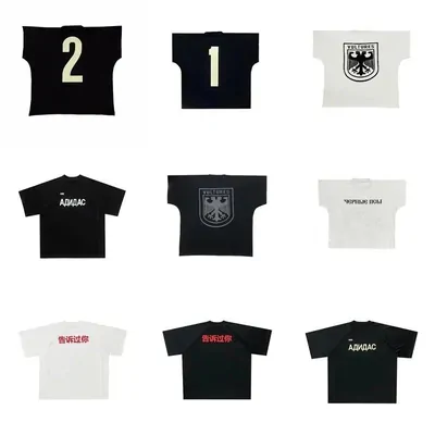 Nine short-sleeved tees laid out in three rows, black and white, with printed graphics